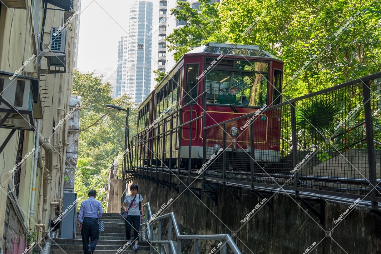 山頂へ向かうピークトラムと階段を上り下りする人
