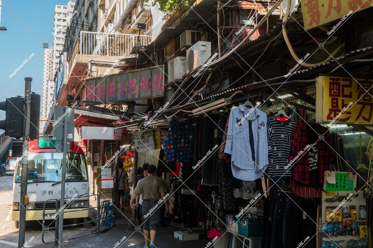 Peoples passing through the old shops in Yue Man Square at Kwun Tong