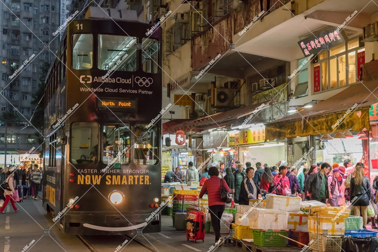 Hong Kong Tramway that passes through the Spring Street in the evening