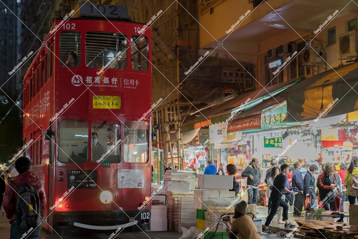 Hong Kong Tramway passing through the shopping street of spring street at night No.4