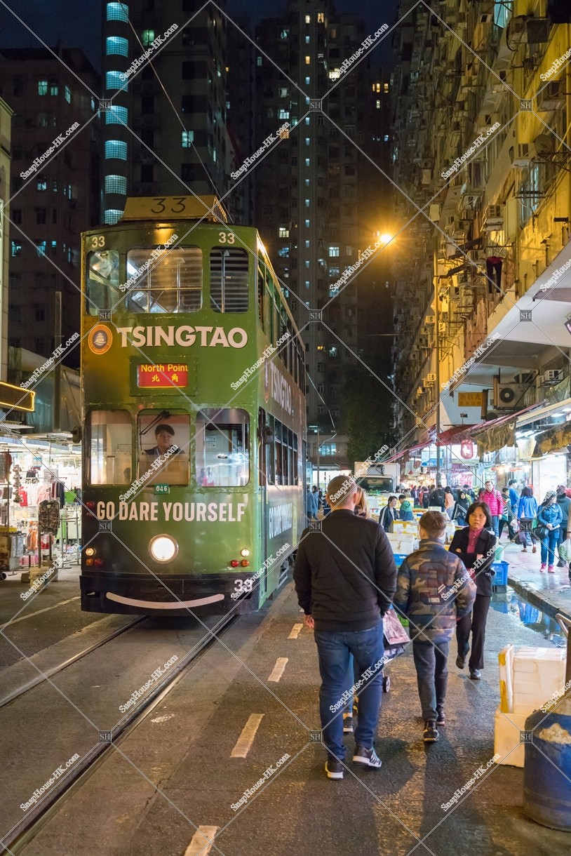 Hong Kong Tramway passing through the shopping street of spring street at night [Portrait]