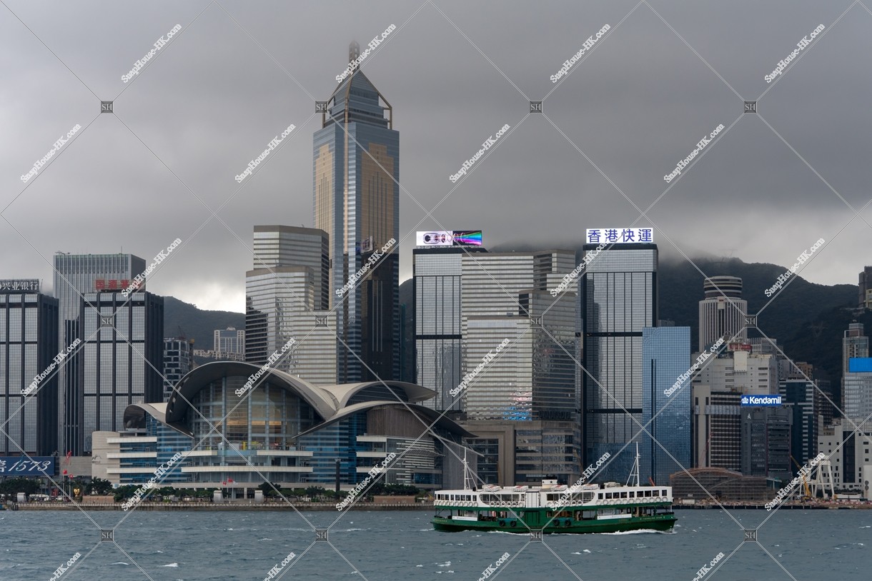 The high-rise buildings at Wan Chai and Star Ferry on a cloudy day [Landscape]