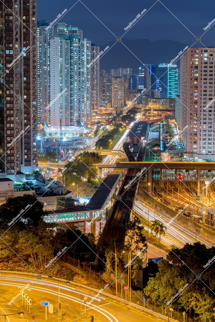 Night view of MTR Kowloon Bay Station and the nearby buildings and mansions [Portrait]