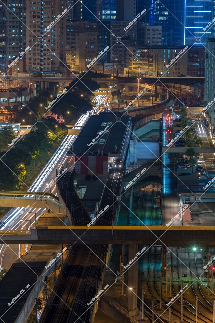 MTR train stopping at Kowloon Bay Station at night