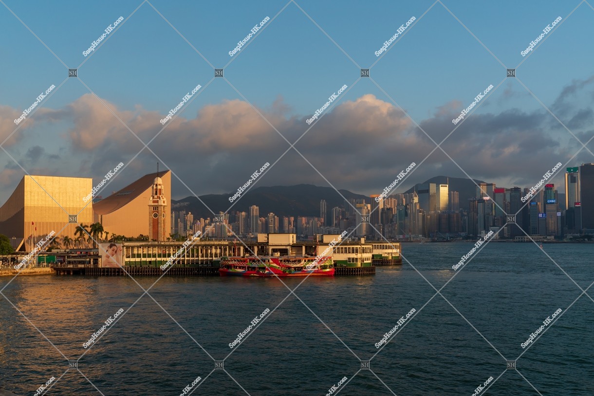 Tsim Sha Tsui Ferry Pier and high-rise buildings at Hong Kong Island in sunset time, No.5