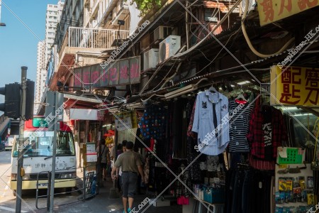 Peoples passing through the old shops in Yue Man Square at Kwun Tong