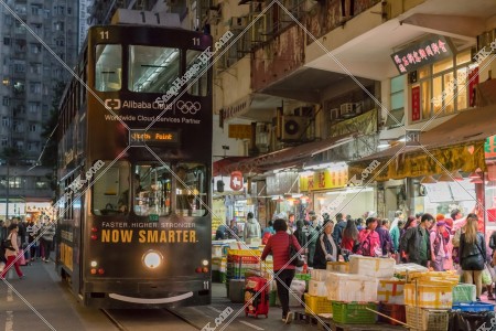 Hong Kong Tramway that passes through the Spring Street in the evening