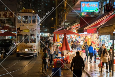Crowded people and the Hong Kong Tramway in the Spring Street at night