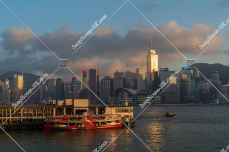 Tsim Sha Tsui Ferry Pier and high-rise buildings at Hong Kong Island in sunset time, No.3