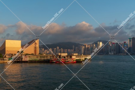 Tsim Sha Tsui Ferry Pier and high-rise buildings at Hong Kong Island in sunset time, No.5