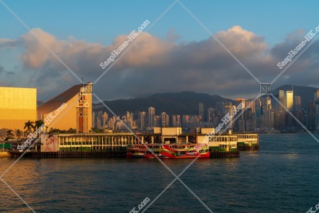 Tsim Sha Tsui Ferry Pier and high-rise buildings at Hong Kong Island in sunset time, No.6